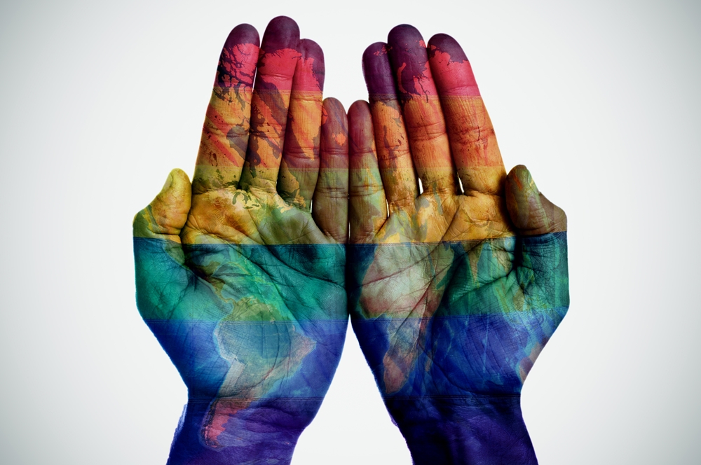 Rainbow-Painted Hands with World Map