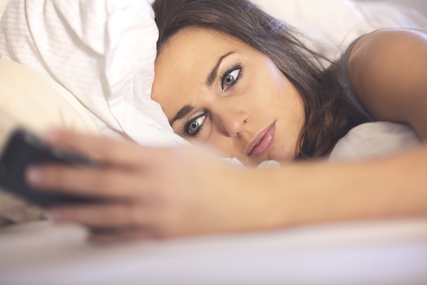 Sexy Woman on Cell Phone in Bed